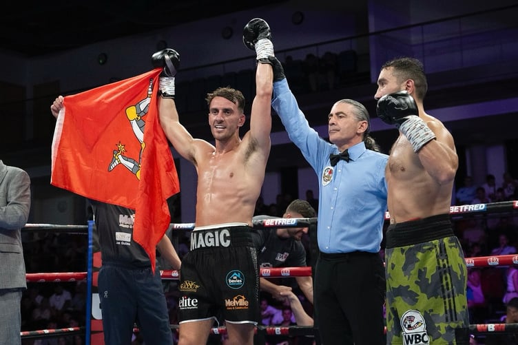 Manxman Mathew Rennie's arm his held aloft after beating Romanian Octavian Gratii