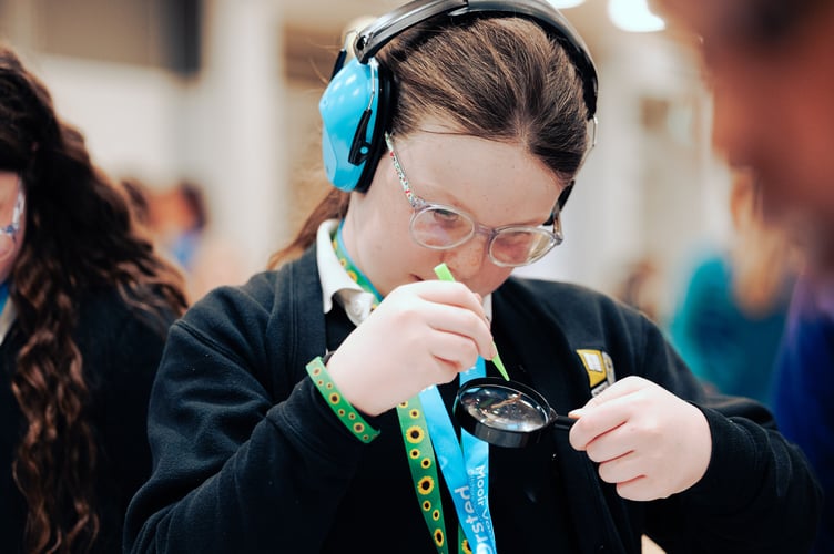 A student trying out one of the exhibits