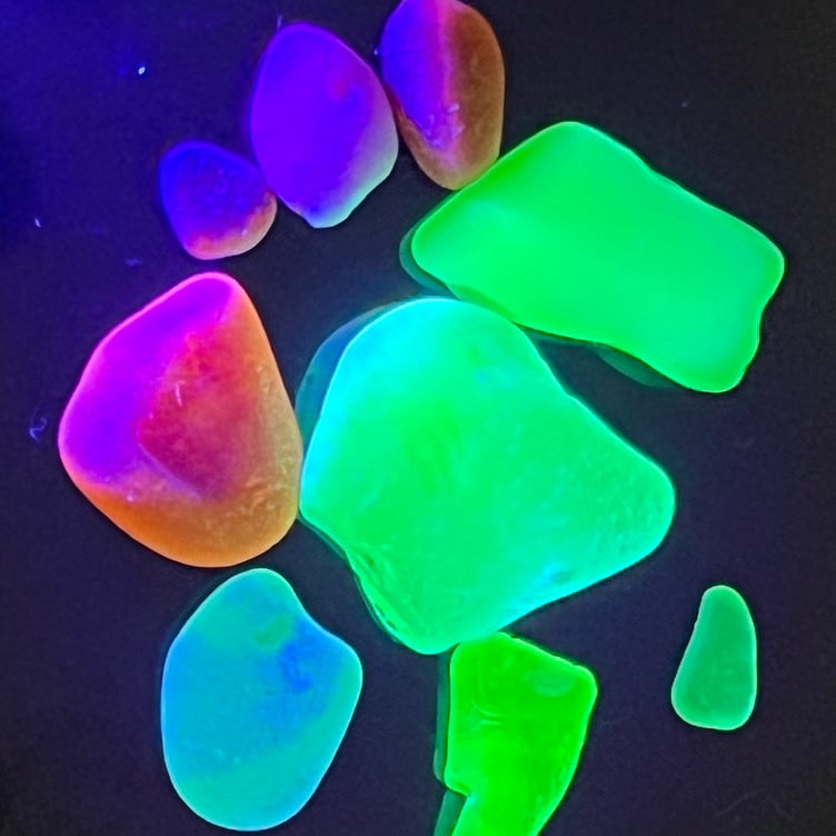 Uranium and red sea glass glowing under a UV light