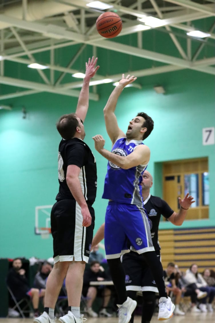 Wolves' Kyle Mills (right) shoots a floater over Michael Baker of Jets at the NSC on Thursday evening. Wolves were back on form as they grounded Jets 58-47 and claimed the top of the table trophy (Photo: Oliver Hamilton)