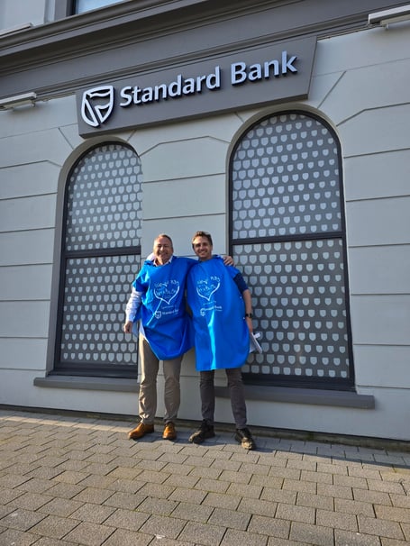 Stand Bank Offshore's Lee Francis with Isle of Play's Chris Gregory (right) and the event's 'I Gave it a Try-Athlon' poncho towel