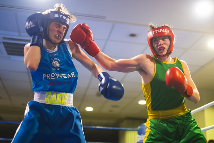 New Horizon's Towson Barton (right) aims a punch at Zacary Smith during their junior bout at the Palace Hotel (Photo: Steve Babb)