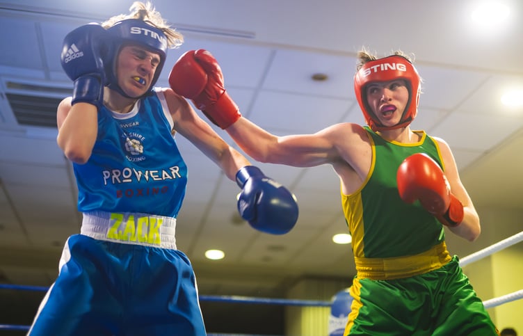 New Horizon's Towson Barton (right) aims a punch at Zacary Smith during their junior bout at the Palace Hotel (Photo: Steve Babb)
