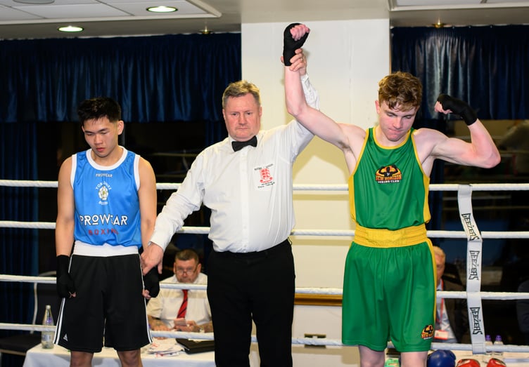 Onchan teenager Mickey Bucknall has his arm raised by the ref after winning his youth contest against Yorkshire’s Zhi Chew at New Horizon Boxing Club's home show recently (Photo: Steve Babb)