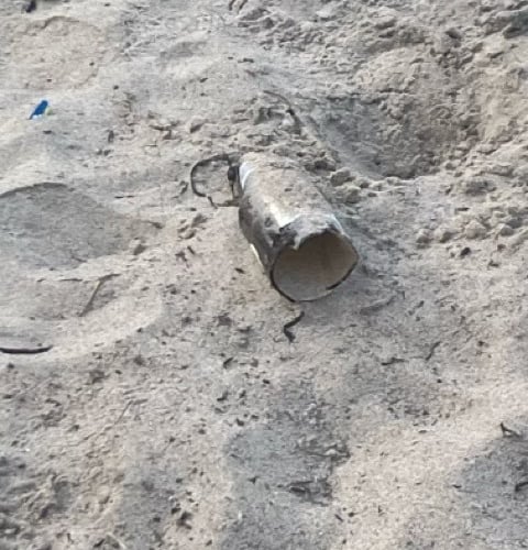 A broken bottle in the sand