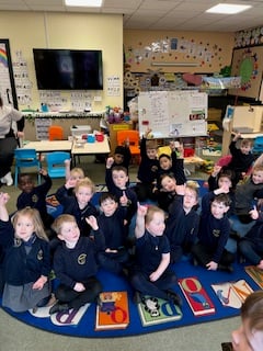 Island schoolchildren with purple fingers after planting their crocus's