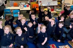 Island schoolchildren with purple fingers after planting their crocus's