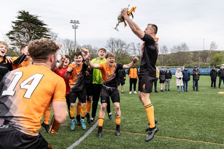 Ayre United captain Jamie Callister hoists the FA Cup aloft to kickstart the celebrations at the Bowl on Saturday (Photo: Gary Weightman)