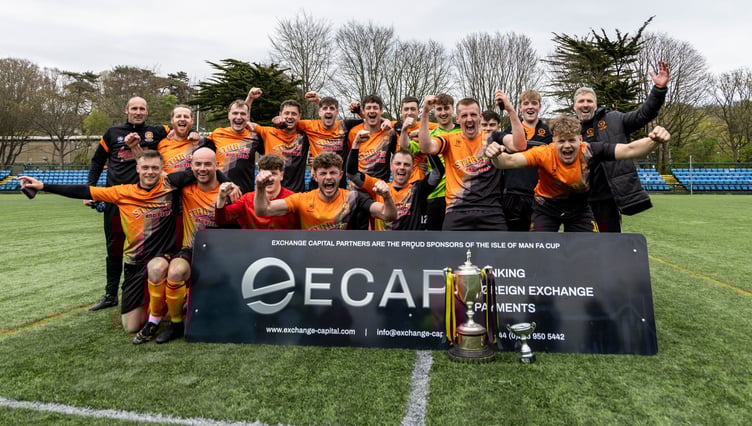 Ayre United players celebrate winning the ECAP FA Cup after beating Foxdale in the final at the Bowl on Easter Saturday (Photo: Gary Weightman)