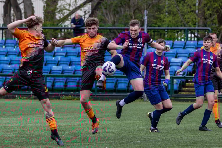 Foxdale captain Scott Kermeen (right) and Ayre's Shaun Kelly acrobatically challenge for an aerial ball during the ECAP FA Cup final (Photo: Gary Weightman)