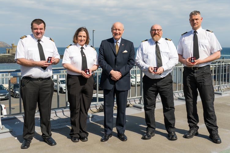 His Excellency the Lieutenant Governor Sir John Lorimer (centre), pictured with King’s Coronation Medal recipients, from left, senior watch officers Andrew Quane, Sarah-Jayne Sleddon and Mark Bentley and watch officer Daniel Aulton