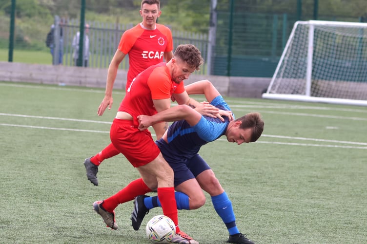 Daniel Pickering tussles with a Halewood Apollo opponent during Saturday's match while Sean Doyle watches on in the background (Photo: Paul Hatton)