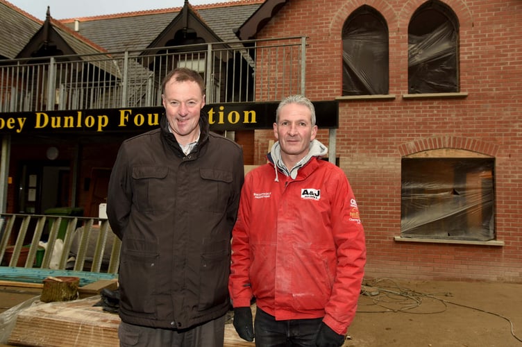 Work to extend Braddan Bridge House in 2017, to increase the amount of specialist accommodation offered by the Joey Dunlop Foundation - pictured is Kevin Quirk (JDF, in black) and Andy Faragher (A&J Builders, in red)