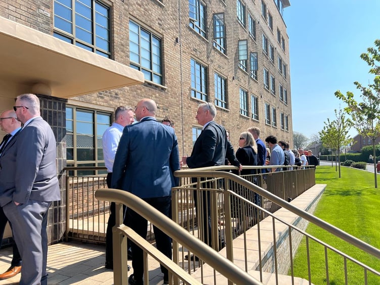 A number of MHKs gather outside the front of Thie Clag and are treated to nibbles and champagne