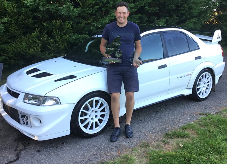 Local driver Sam Beevers with his Manx Classic Hillclimb trophies after dominating the three-day event in his Mitsubishi Evo 6 RS