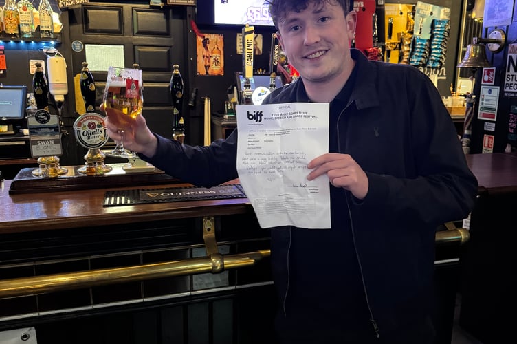 Tom showing off his stand-up comedy score card like he'd won something important - along with his well-deserved pint