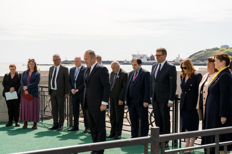 The Chief Minister and members of Tynwald pay their respects during a period of silence