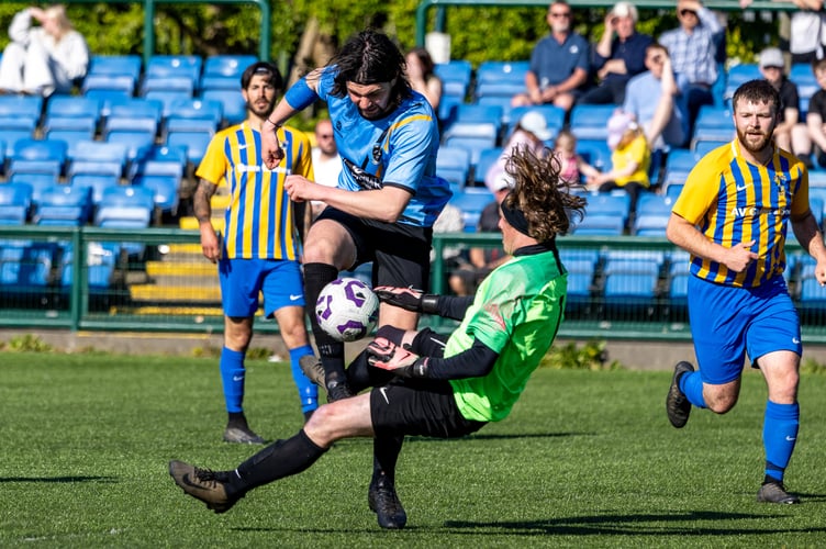 Rushen United striker Jordan Watterson is challenged by St John's goalkeeper Matthew Beattie during the weekend's Junior Cup final at the Bowl (Photo: Gary Weightman)