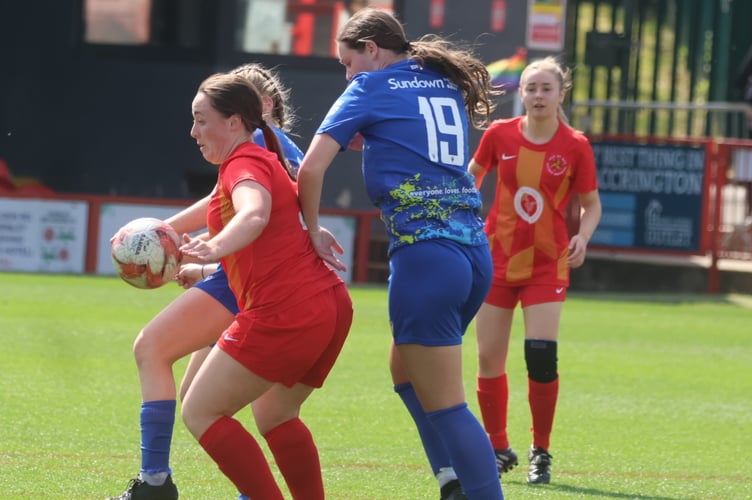 The Isle of Man's Anna Shaw (left) attempts to hold off two Accrington opponents during Saturday's match (Photo: Paul Hatton)