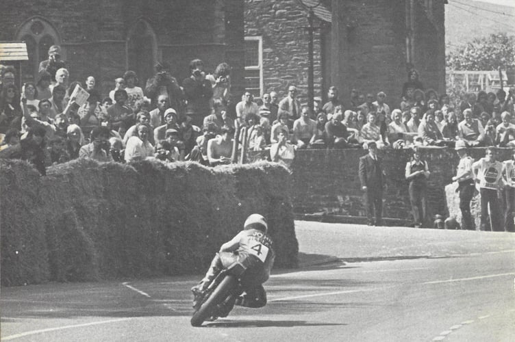 John Williams passes the crowds at Braddan church en route to winning the Classic TT on his 350cc Yamaha twin with a prize of £1,500