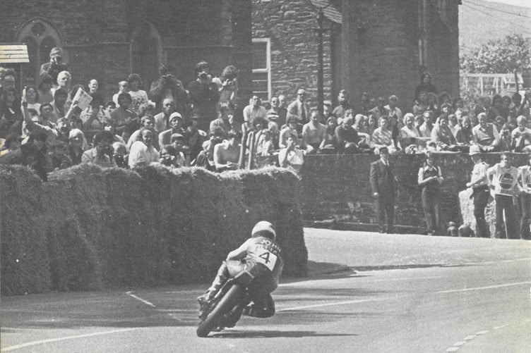 John Williams passes the crowds at Braddan church en route to winning the Classic TT on his 350cc Yamaha twin with a prize of £1,500