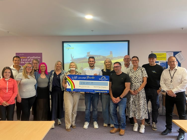 The skydiving participants with the cheque for Rebecca House