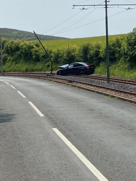 The crashed car and damaged pole between Groudle Glen and Eskadale