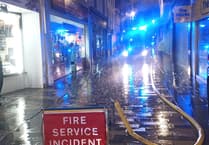 Emergency services called to Douglas shopping street after store front catches fire