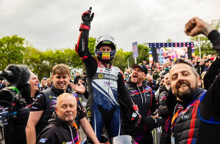 Santon man Mikey Evans celebrates in the winners' enclosure with his team after clinching a maiden TT podium when finishing second in Tuesday evening's opening Supertwins race (Photo: www.iomttraces.com)