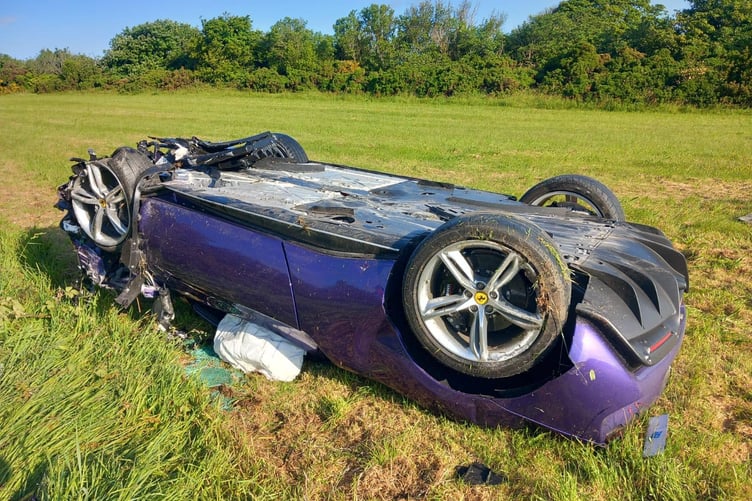 Ferrari ended up on its roof in a field after a crash on the Mountain Road