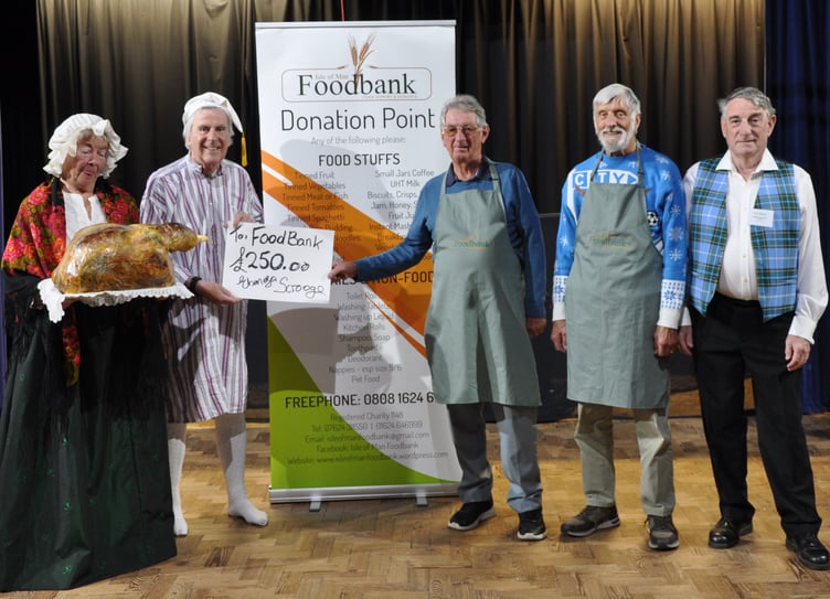 Members of the Rushen Players with representatives from the Isle of Man Foodbank