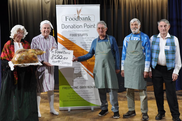 Members of the Rushen Players with representatives from the Isle of Man Foodbank