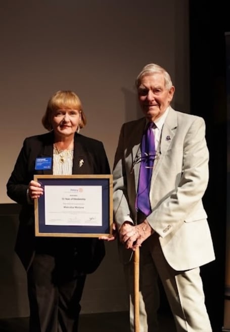 Rotary International President Stephanie Urchick presents Malcolm Watson with his certificate for his 55 years service to Rotary