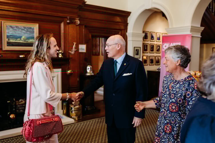 Owen Atkinson is welcomed by both the Lieutenant Governor Sir John Lorimer and Lady Lorimer