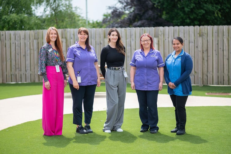 Peta with employees at Rebecca House