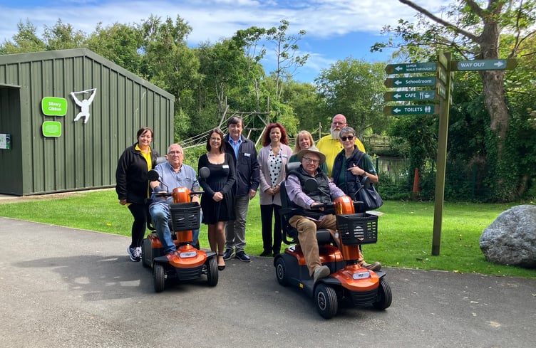 Photos (left to right): Sally Ferguson (director Kissack Care Ltd); Sarah Maltby MHK (Manx Lottery Trust trustee); Trevor Butler (Chief operating officer, Manx Lottery Trust); Ashley Roche (Administration assistant, Manx Lottery Trust); Kathleen Graham (Curraghs Wildlife Park general manager); Nick Wildon (Engineer, Kissack Care Ltd); Kim Etherton (Chair supporters of the Curraghs Wildlife Park); Ron Thomas and George Meddes trying out the new scooters