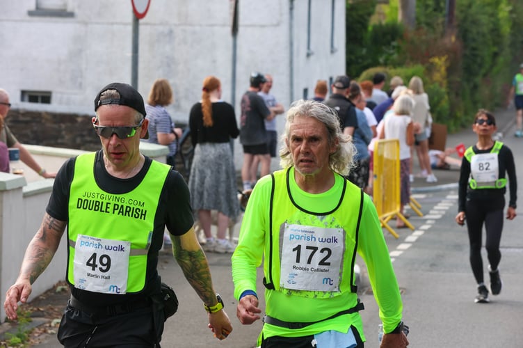Martin Hall (left) on the second-leg of his monumental 'Double Parish' challenge through Glen Vine, pictured with five-time Parish Walk winner Robbie Callister 