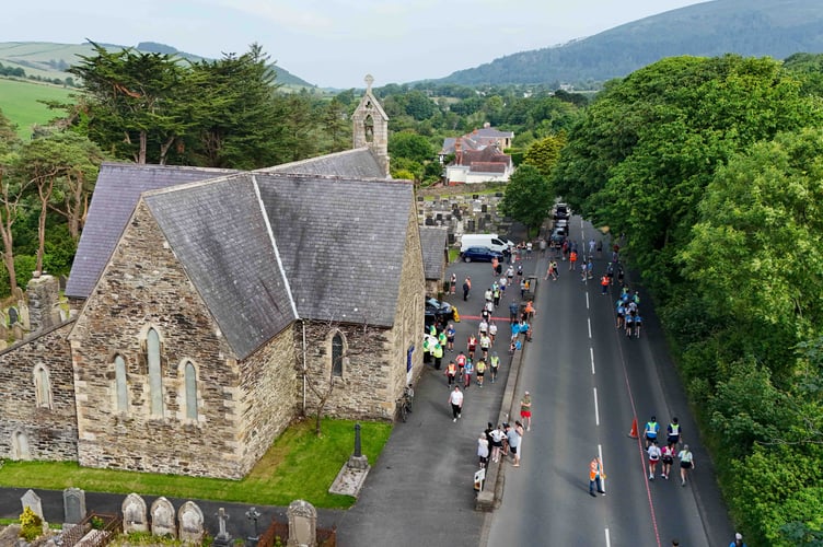 Walkers passing through Marown Church