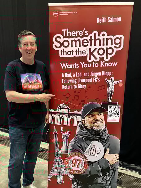Keith Salmon with a banner promoting his new book 'There's Something That The Kop Wants You To Know'
