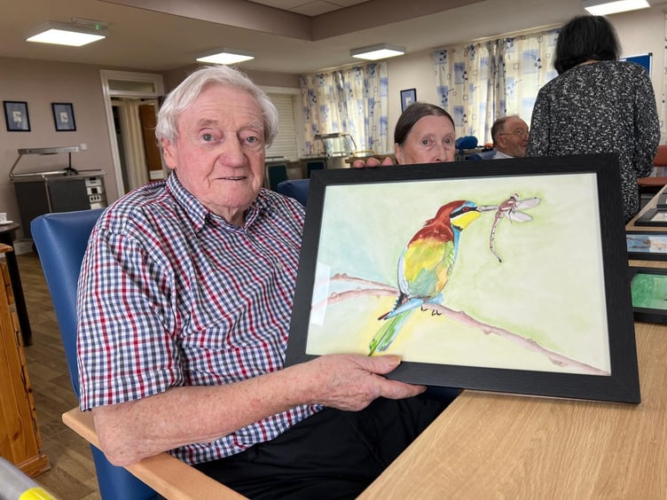 Chris Walsh holding up Ian's drawing of a bird