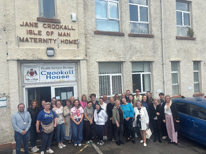 Staff in front of Crookall House on moving day