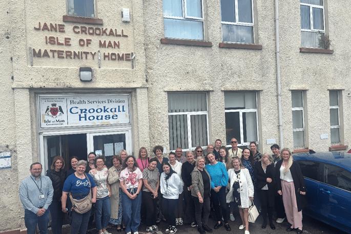 Staff in front of Crookall House on moving day