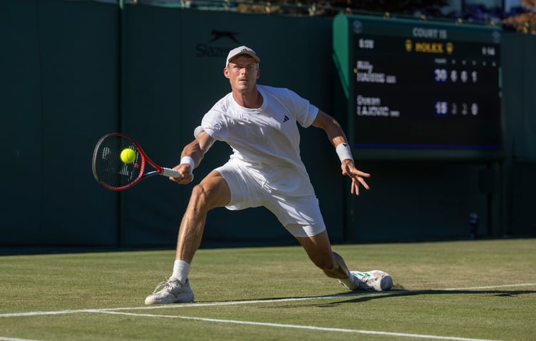 The Isle of Man's Billy Harris plays a forehand against Serbia's Dusan Lajovic in the first round match of the men's singles at Wimbledon on Monday. The former Castletown and Albany player won in straight sets (Photo: AELTC/Peter Nicholls)