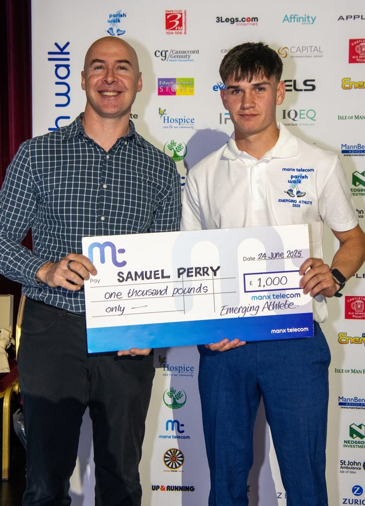 Sam Perry receives the 2025 Manx Telecom Parish Walk Emerging Athlete Award from MT's chief technology officer Hugo Van Zyl (Photo: Mark Corlett)