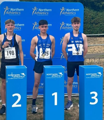 Sam Perry (centre) on the podium at the Northern Athletics Championships