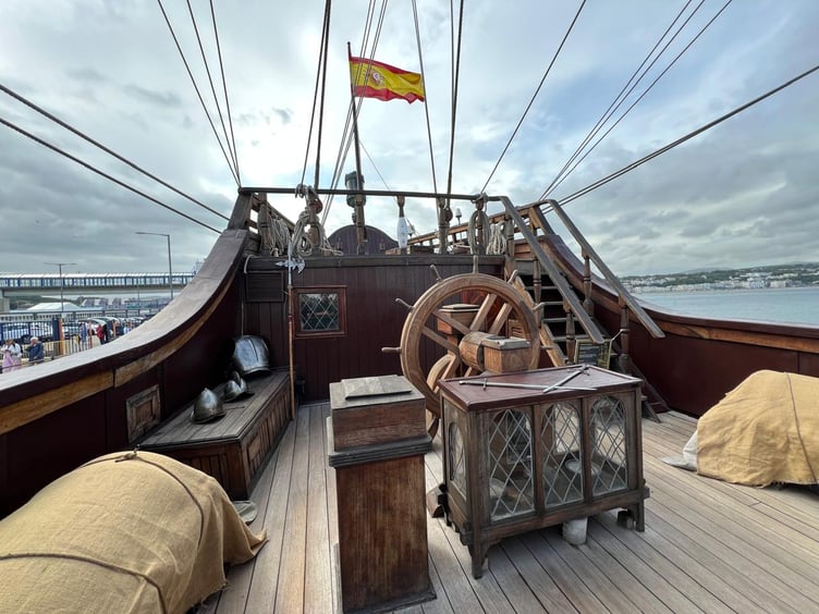 The Spanish flag is raised high on the upper deck