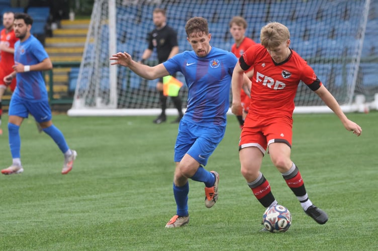 FC Isle of Man's Kyle Watson (right) competes for possession with Isle of Man FA player Dan Pickering during Friday's clash (Photo: Paul Hatton)