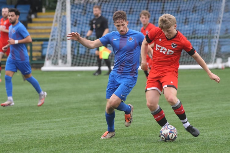 FC Isle of Man's Kyle Watson (right) competes for possession with Isle of Man FA player Dan Pickering during Friday's clash (Photo: Paul Hatton)