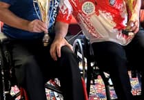 Kennish battles injury to stay top of British darts rankings