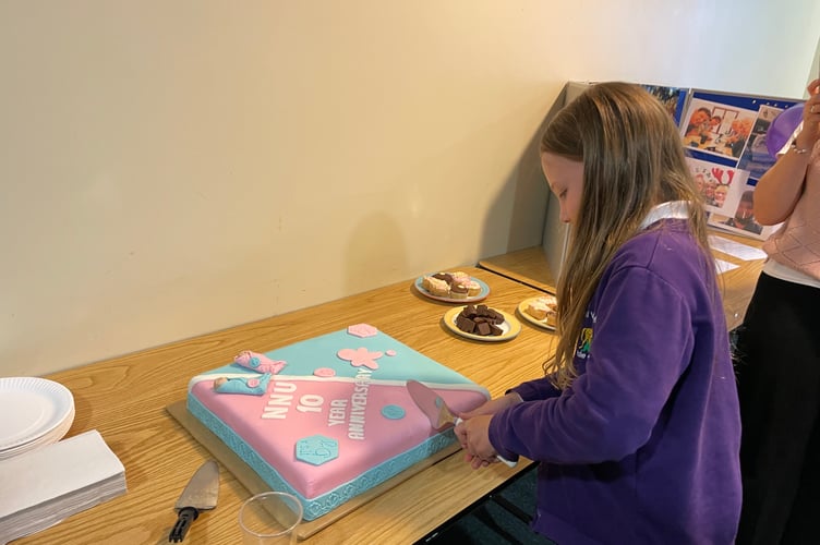 Evie Rose-Hill cutting the cake for the celebration.